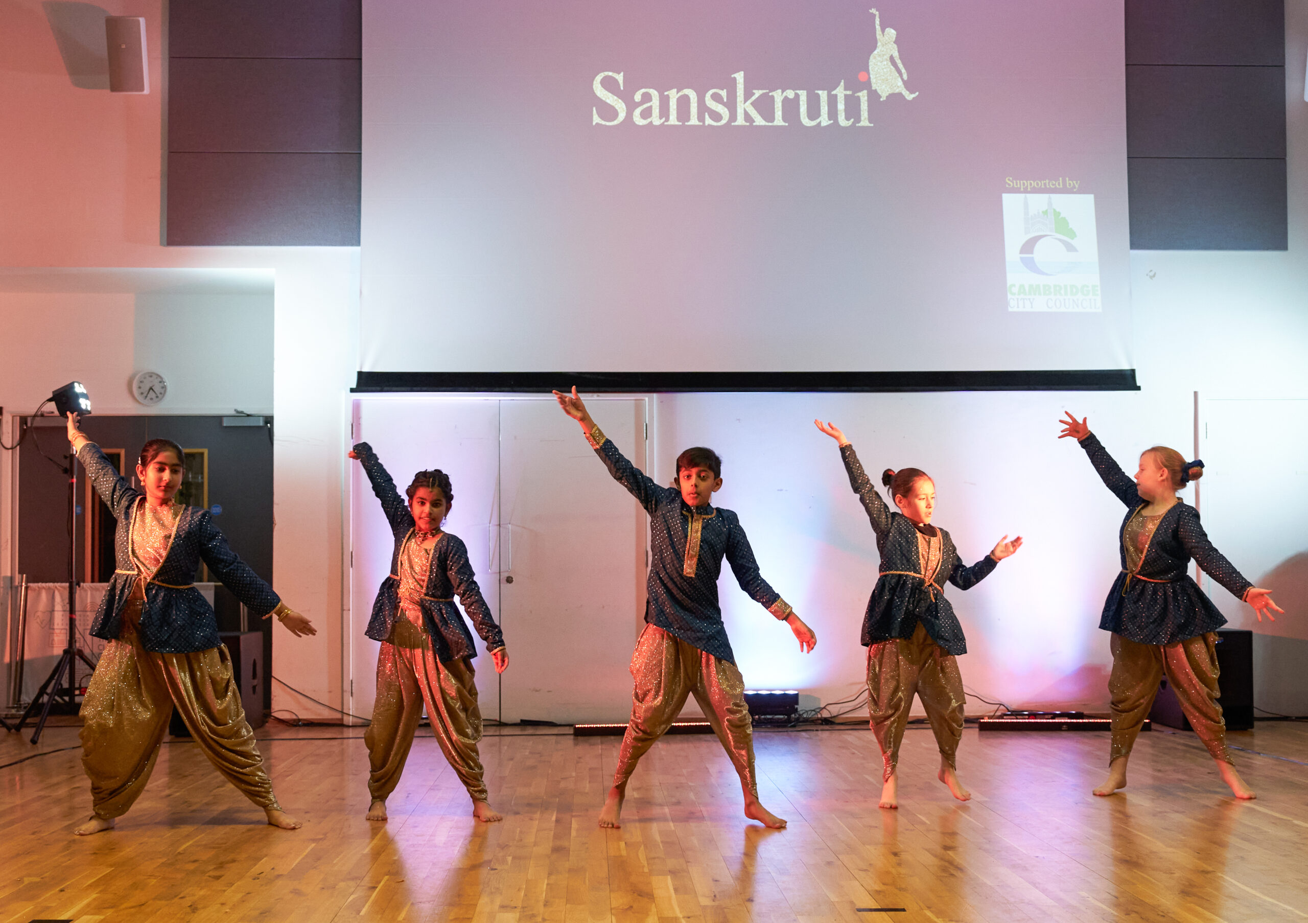 Children performing at Rangeela in blue and gold costumes